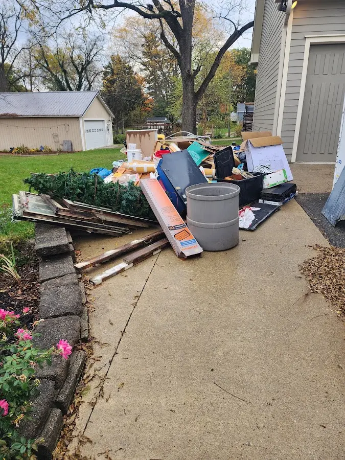 Dumpster being loaded with debris for 12 Yard Dumpster Rental in Austintown